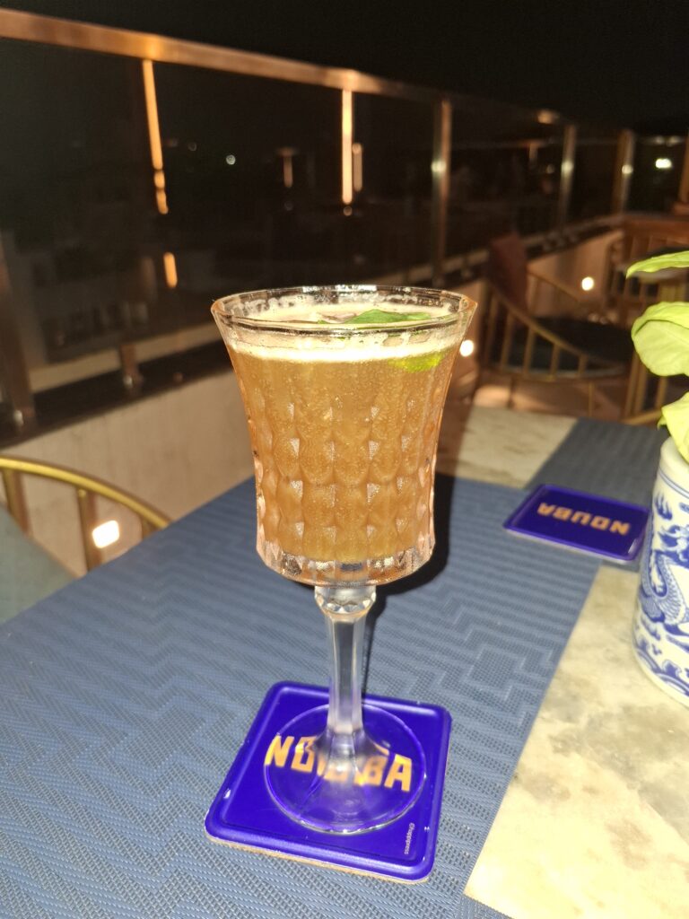 Vintage Rumwood Royale cocktail in a crystal stemmed glass on a Nouba coaster, Jaipur