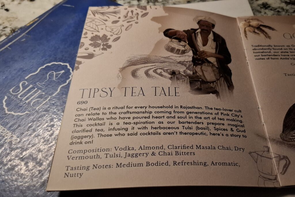 Sura menu page for Tipsy Tea Tale, with an illustration of a chai wallah pouring tea, priced at ₹690
