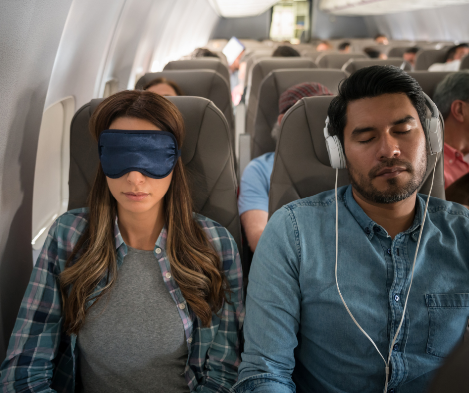 Two airline passengers sleeping during a flight, one wearing an eye mask and the other listening to music, illustrating the effects of in-flight conditions on rest