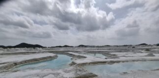 Turquoise pools and cracked white ground at Kishangarh dumping yard, Rajasthan