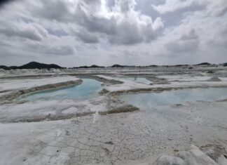 Turquoise pools and cracked white ground at Kishangarh dumping yard, Rajasthan