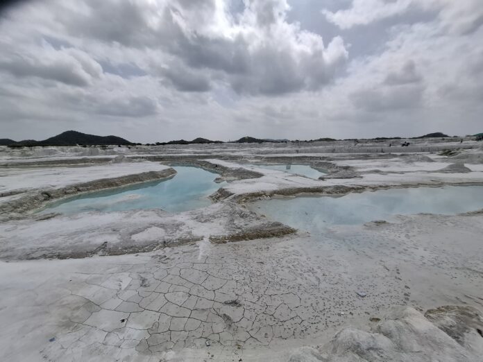 Kishangarh dumping yard pools Turquoise pools and cracked white ground at Kishangarh dumping yard, Rajasthan